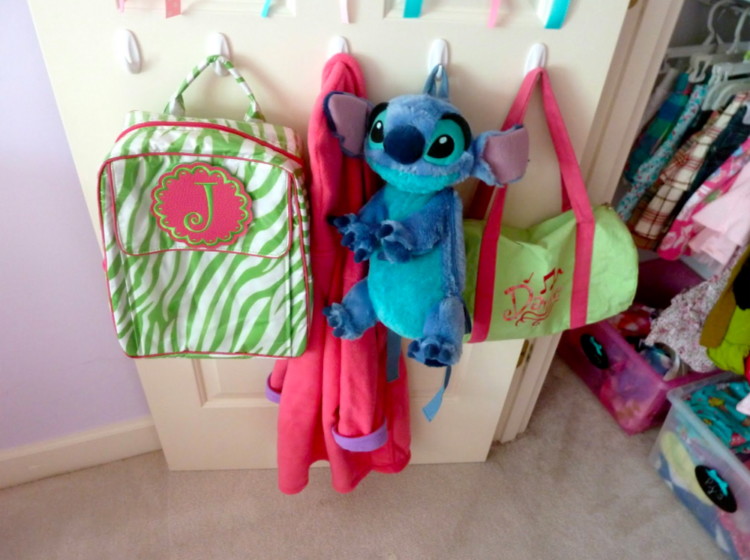 Hang bags and coats from Command Hooks attached to the closet door.