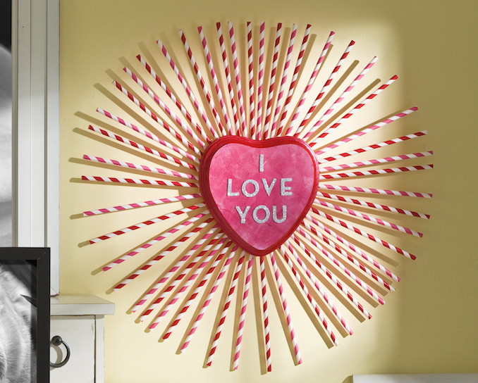 Create an "I Love You" wreath with paper straws and a heart shaped plaque