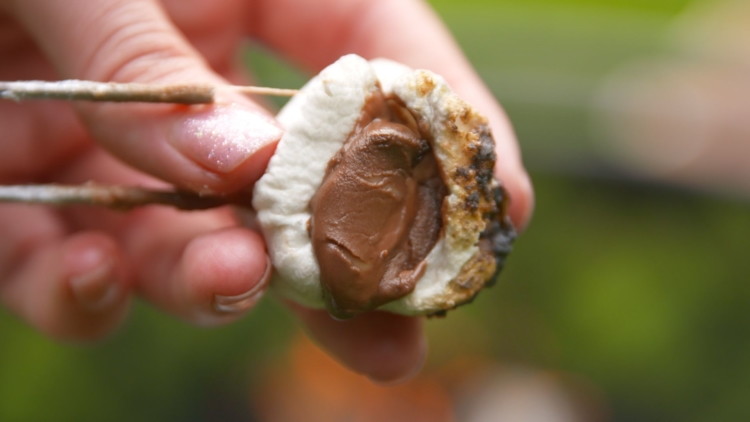 Put a square of chocolate in the marshmallow before roasting it.